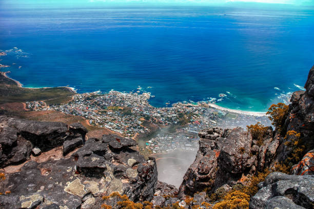 Cape Town from Table Mountain View of Cape Town and the coastline from Table Mountain, with the typical "table cloth" clouds seen from above. table mountain and the tablecloth stock pictures, royalty-free photos & images