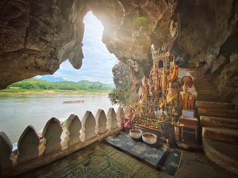 Sunbeam into the Pak Ou Cave Buddha Shrine at Tham Ting Buddhist Cave. Pak Ou, Mekong River, Luang Prabang, Laos, Southeast Asia.