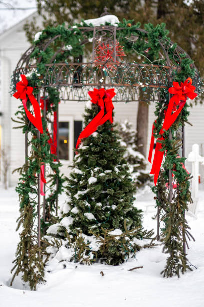 istock Christmas tree with red bows and garland outdoors 1185997139