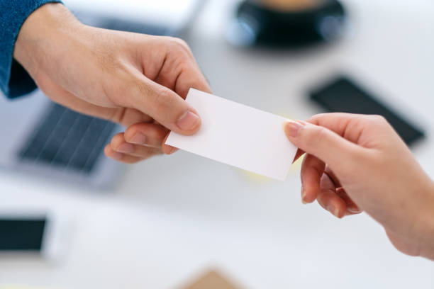istock businessman holding and giving empty business card 1185998030