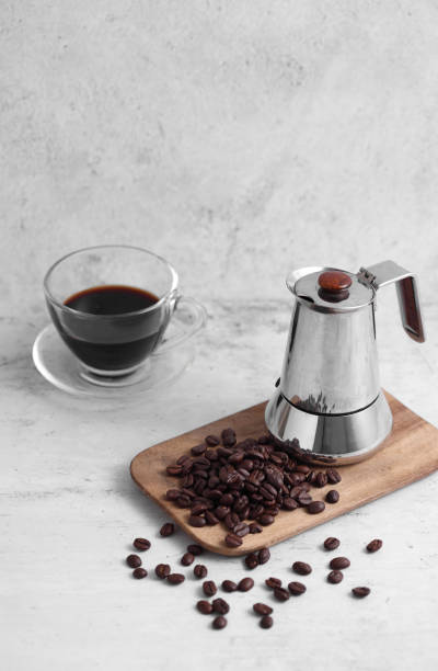 istock Coffee in cup and mocha pot on rustic table with a blank space for a text, Espresso in cup on white background 1186016766