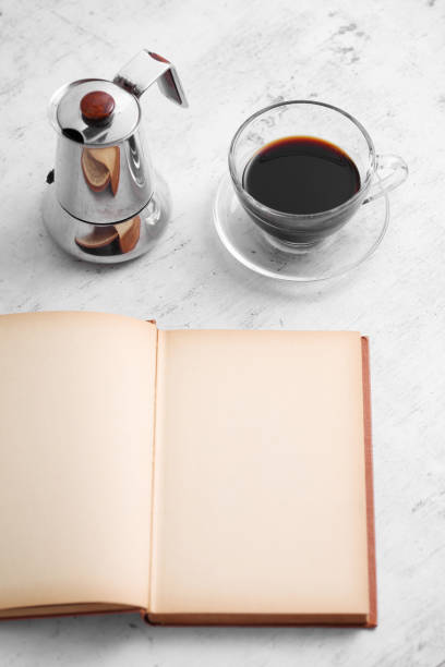 istock Coffee in cup and books on rustic table with a blank space for a text, Espresso in cup on white background 1186016775