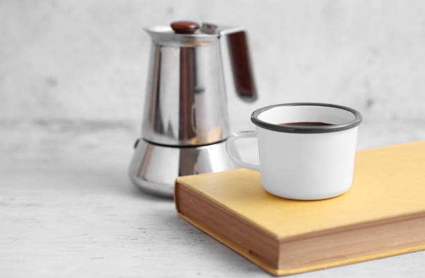 istock Coffee in cup and books on rustic table with a blank space for a text, Espresso in cup on white background 1186018717