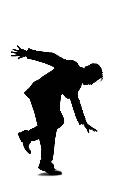 istock Side View Silhouette of a Businessman Falling or Balancing 1186018954