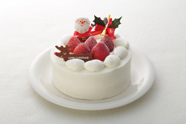 Image of Christmas cake taken in close-up Christmas cake with Santa Claus, dwarf, tree, ornament, white background christmas cake stock pictures, royalty-free photos & images