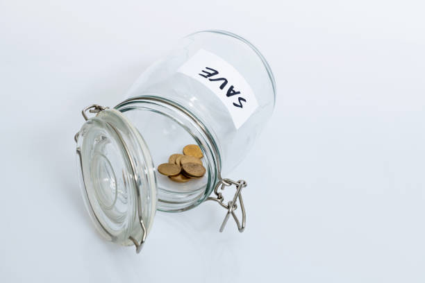 istock Coins in glass jar with word SAVE 1186021787