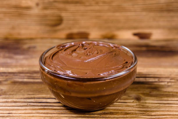 istock Glass bowl with chocolate spread on a wooden table 1186022681