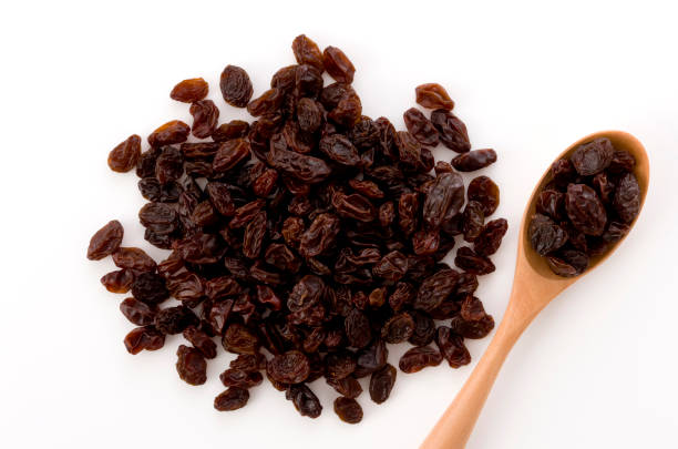 istock Dried raisins in a wooden spoon 1186022733