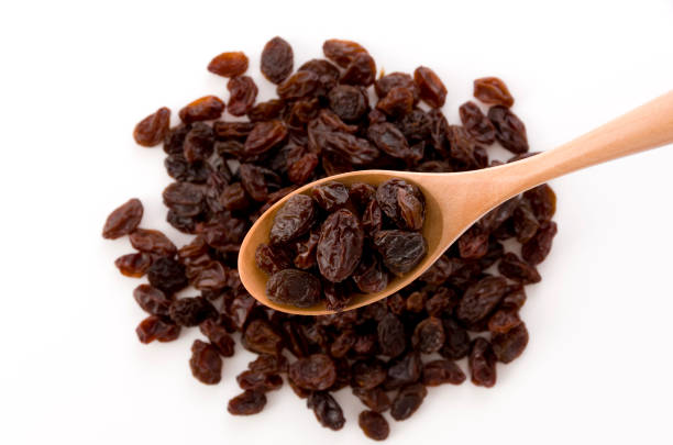 istock Dried raisins in a wooden spoon 1186022875