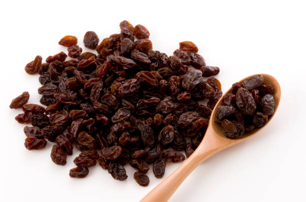 istock Dried raisins in a wooden spoon 1186024647