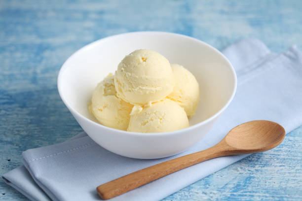istock vanilla ice cream on a blue background with a blank space for a text, vanilla ice cream in white ceramic cup 1186025454