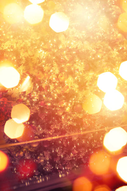 Christmas Tree Reflection on a Grand Piano with Defocused Lights.