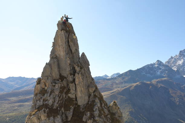 istock Mountaineers celebrate on to pinnacle summit 1186033396