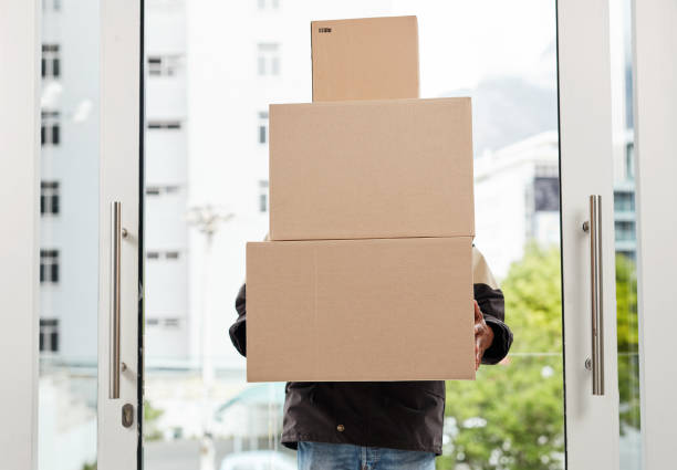 Cropped shot of a courier using a digital tablet while making a delivery