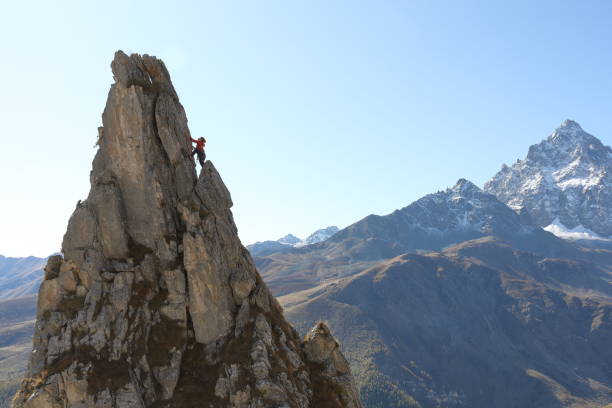 istock Female mountaineer ascends to mountain summit 1186037706