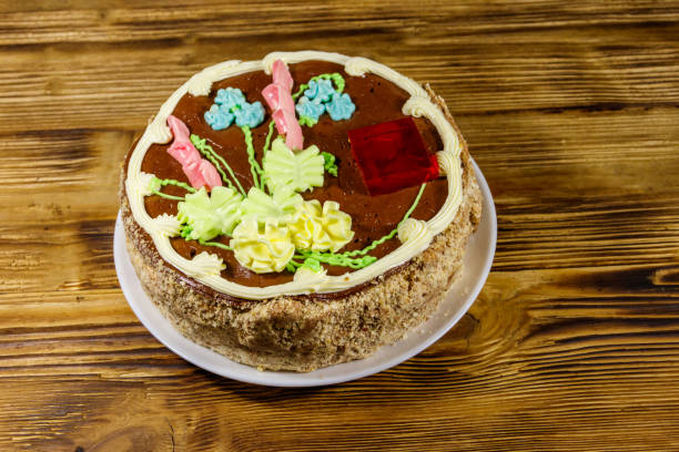 istock Kiev cake with cream, nuts and meringue on wooden table 1186038837