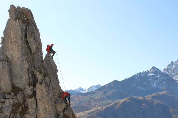 istock Mountaineers ascend to mountain summit 1186039294
