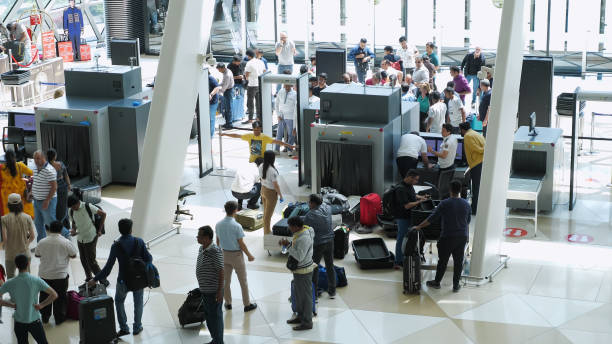 i passeggeri sono in fila ai raggi x nel posto di blocco all'ingresso del terminal dell'aeroporto. - turismo di eco foto e immagini stock