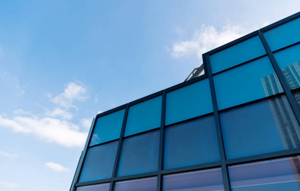 istock Cloud sky reflected on glass windows of modern building 1186041479
