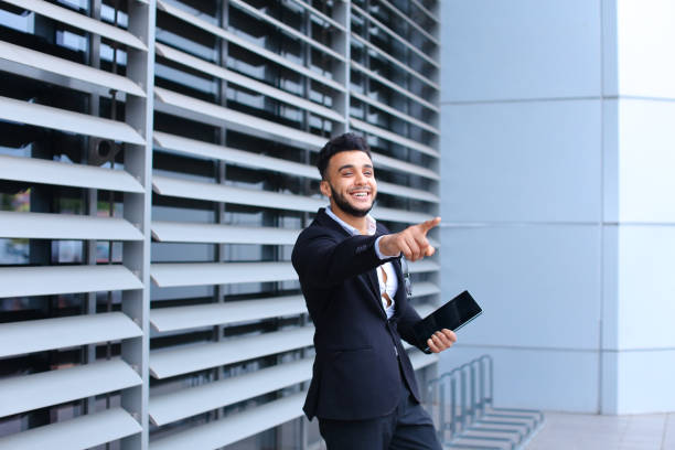istock Arabic guy in business center stands smiling 1186044393