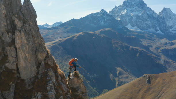 istock Mountaineer relaxes on mountain slope 1186044497