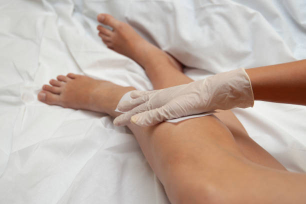 istock Waxing epilation on woman's legs 1186046470