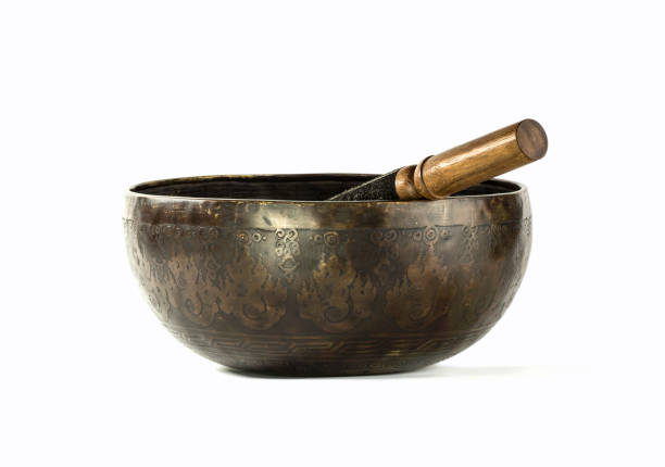 Antique Singing bowl, Ladakh, Tibet, Himalayas Studio shot of an antique singing bowl (ring gong, resting or standing bell) made of brass with a wooden striker. This is a typically music instrument used Himalayan regions in Tibet and Ladakh. gong stock pictures, royalty-free photos & images