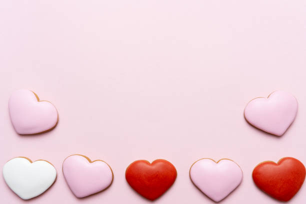 istock Valentine's Day background with red hearts on pink background 1186052624