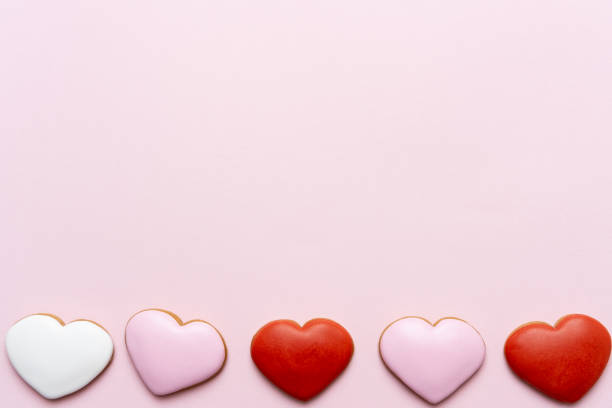 Valentine's Day background with red hearts on pink background stock photo
