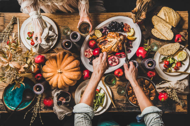 istock People eating festive dinner on Thanksgiving day with cat 1186052954