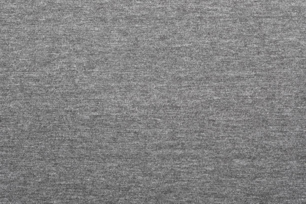 Heather grey knitted fabric textured background Heather grey knitted fabric made of melange mixed yarn textured background jersey fabric photos stock pictures, royalty-free photos & images