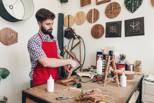 Attractive wood craftsman working in his atelier