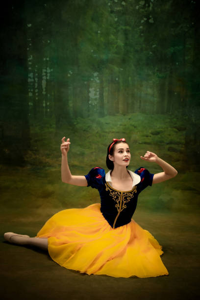 istock Young ballet dancer as a Snow White with poisoned apple in forest 1186056330