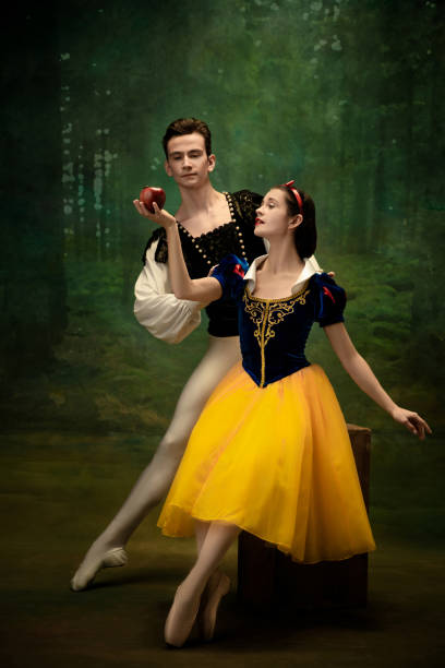 istock Young ballet dancers as a Snow White's characters in forest 1186056394