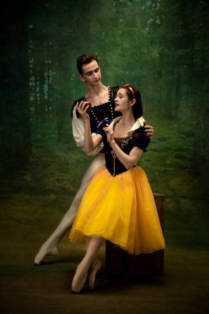 istock Young ballet dancers as a Snow White's characters in forest 1186056400