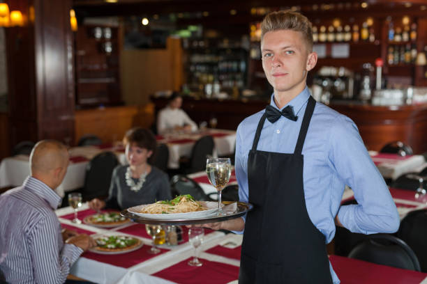 istock Waiter with tray in restaurant 1186056436