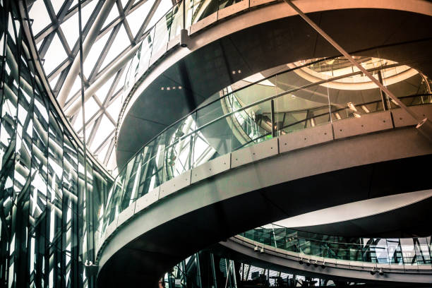 A modern glass roof structure allowing tree reflections, showcasing clean lines and transparent design.