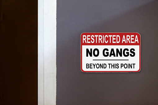 Red and white restricted area sign on the side of an open door stating 