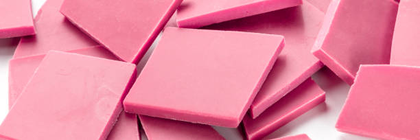 istock A close-up panorama of ruby chocolate slices, broken on a white background 1186059527