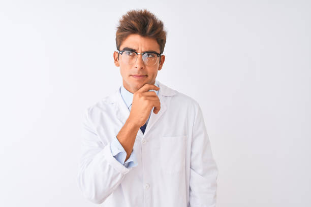 istock Young handsome sciencist man wearing glasses and coat over isolated white background Thinking worried about a question, concerned and nervous with hand on chin 1186061444