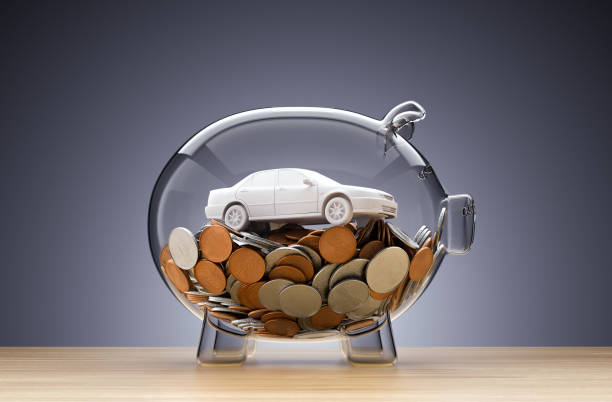 istock Model Car on money inside transparent piggy bank 1186061669