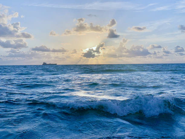 istock shipping vessel and sunrise in the ocean 1186061772