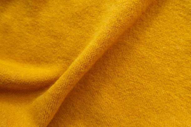 istock Soft fold on amber yellow knitted woolen fabric 1186061843