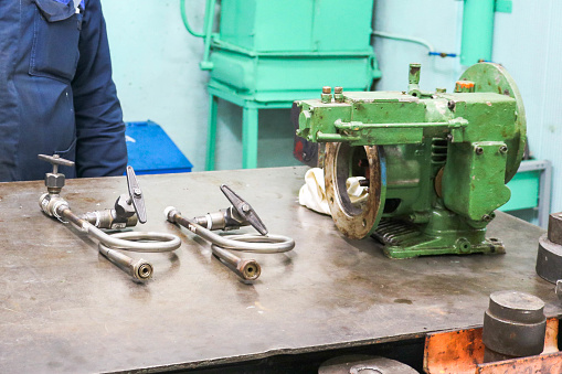 Metallic iron industrial pump plunger, centrifugal and manometric assembly in a metal workshop on the table for the repair and manufacture of parts and spare parts.