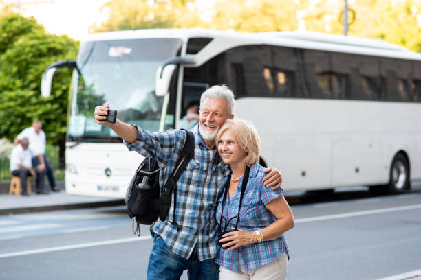 Cheerful senior tourists taking selfie