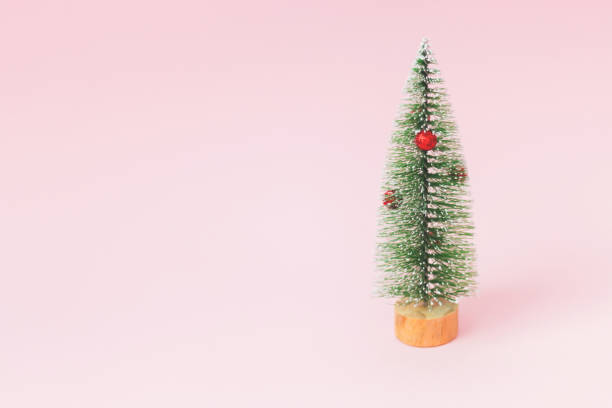 istock Small Christmas decorative fir tree isolated on a white background. Festive christmas background 1186066982