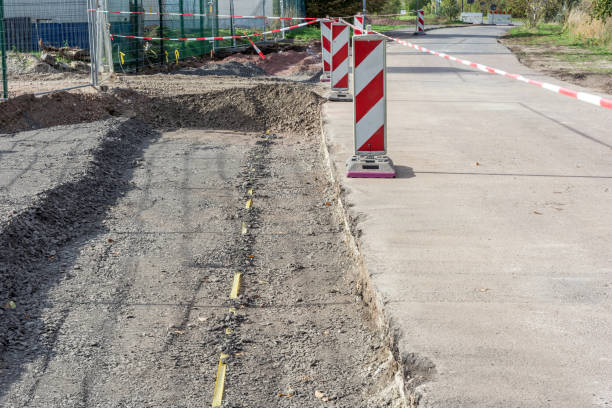 istock Construction of a road with gravel bed and warning beacons 1186067369