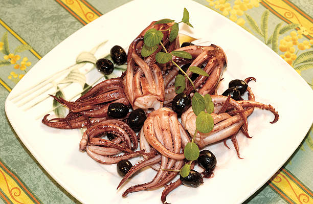 Calamaretti with mint and olives stock photo