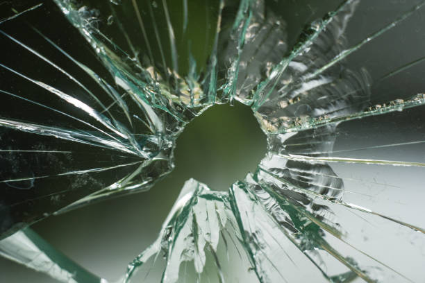 istock bullet hole in the glass 1186072444
