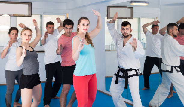 istock adults attempting to master new moves during karate class 1186073097